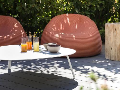 a table with two chairs and drinks on it at Criu Boutique Hotel in Nicolosi
