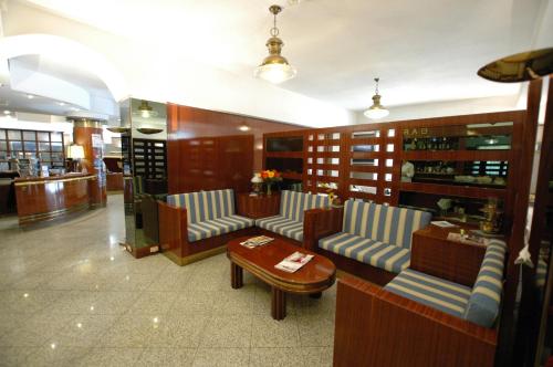 a restaurant with blue and white chairs and a table at Hotel Crystal in Portoferraio
