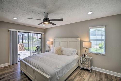 a bedroom with a bed and a ceiling fan at Canal-Front Cape Coral Home: Pool & Patio in Cape Coral