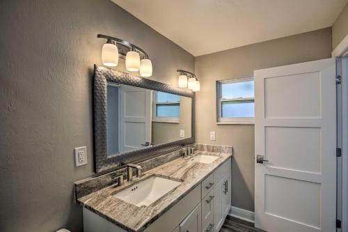 a bathroom with two sinks and a large mirror at Canal-Front Cape Coral Home: Pool & Patio in Cape Coral