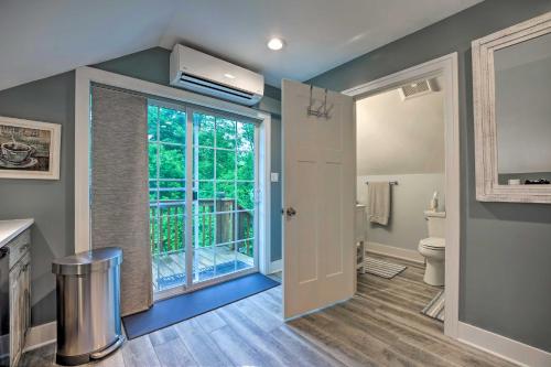 a bathroom with a toilet and a window at Apartment with Private Balcony and Shared Pool in Benton Harbor