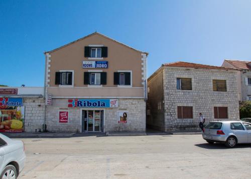 a building with a car parked in front of it at Villa Jidro in Trogir