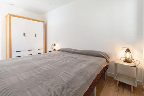 a bedroom with a large bed and a window at Optimist 2 in La Manga del Mar Menor