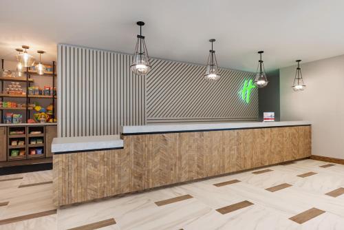 a lobby with a counter with lights on it at Holiday Inn & Suites Ocean City by IHG in Ocean City
