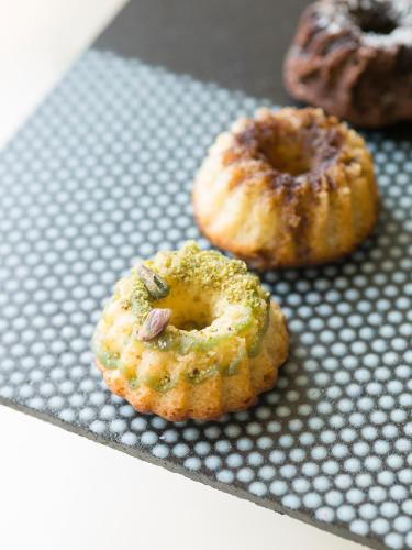 three donuts sitting on top of a metal rack at Criu Boutique Hotel in Nicolosi