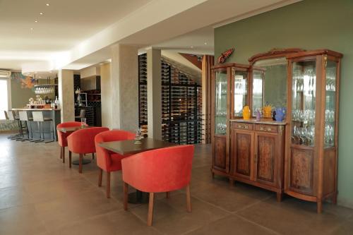 a dining room with a table and red chairs at Gaia Lodge in Tupungato