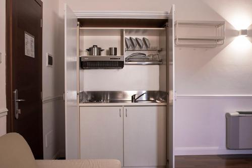 a small kitchen with a sink and a refrigerator at Palazzo Sant'Elena in Foggia