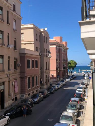 a street with cars parked on the side of the road at Caves Apartment in Bari
