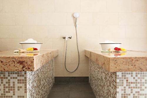 a bathroom with two sinks and a shower at Hotel Im Krummbachtal in Schönau an der Brend