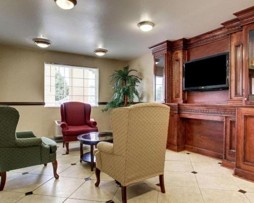 a living room with chairs and a flat screen tv at Days Inn by Wyndham Jackson Downtown in Jackson