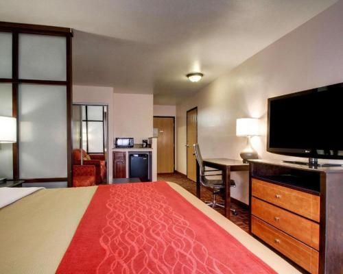 a hotel room with a large bed and a flat screen tv at Days Inn by Wyndham Jackson Downtown in Jackson