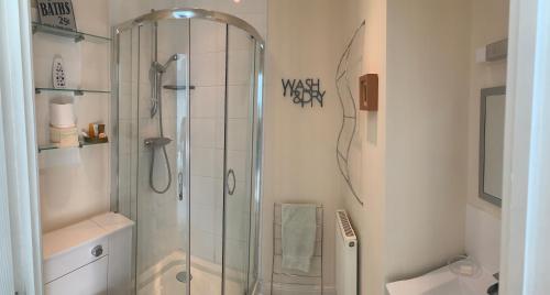 a bathroom with a shower and a toilet at Willow Farm Way in Herne Bay