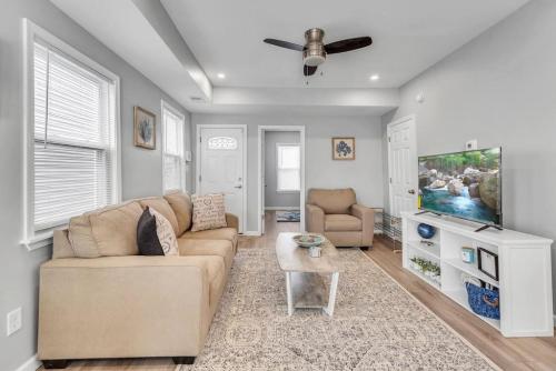 a living room with a couch and a flat screen tv at Dave and Busters, Outlets, Convention Center across street w Parking - Sleeps 15 in Atlantic City