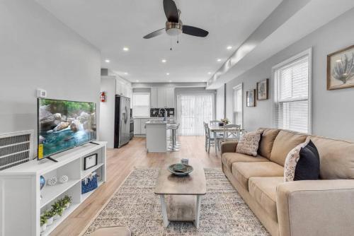 a living room with a couch and a flat screen tv at Dave and Busters, Outlets, Convention Center across street w Parking - Sleeps 15 in Atlantic City