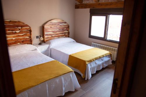 A bed or beds in a room at Casa Rural Zacarías