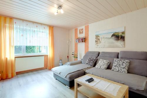 a living room with a couch and a table at Ferienwohnung Lilly in Büdingen