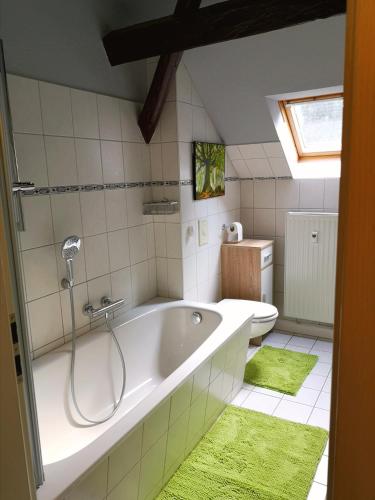 a bathroom with a bath tub and a toilet at Wanderlust in Thermalbad Wiesenbad