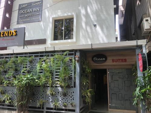 a building with plants in the front of it at Ocean Inn Hotels in Bengaluru