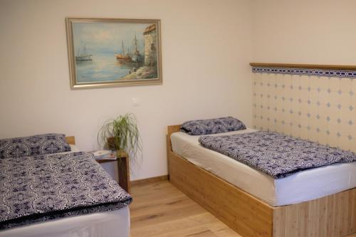 a room with two beds and a picture on the wall at Magnolia Suite in Eisenach