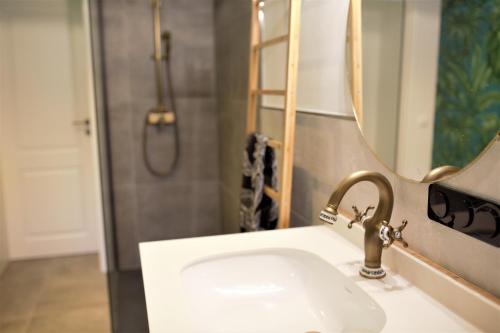 a bathroom with a sink and a mirror at Magnolia Suite in Eisenach