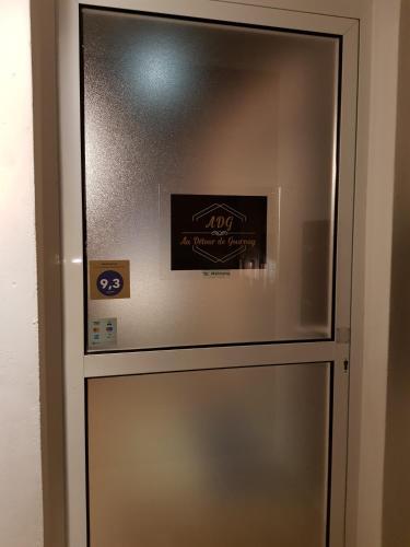 a stainless steel refrigerator with a sign on it at Au detour de Gournay in Gournay-en-Bray