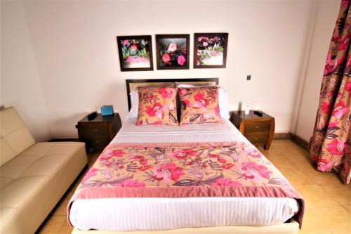 a bedroom with a bed and a couch at Amazilia Hotel in Pereira
