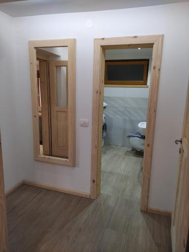 a room with a bathroom with a toilet and a door at Green Garden Apartment in Bled