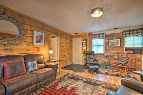 a living room with a couch and a chair at Adirondack Mountains Cottage Near Gore Mountain! in Warrensburg