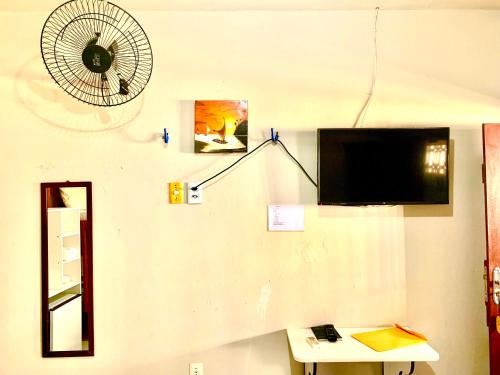 a living room with a fan and a table at Pousada Sol Dourado in Jijoca de Jericoacoara