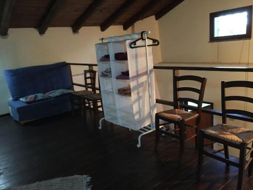 a living room with chairs and a cabinet with shoes at Chalet Etna in Biancavilla