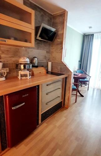 a kitchen with a counter and a dining room at Haus Müritz, FeWo 17 Hecht in Zielow