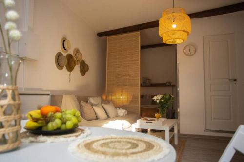a living room with a table with a bowl of fruit at Le Bohème, Cosy, Hypercentre in Grenoble