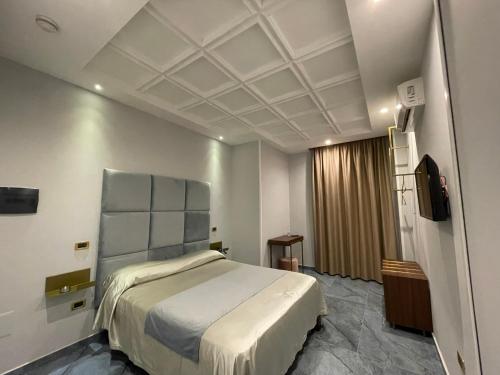 a hotel room with a bed and a television at Ninfa hotel in Qualiano