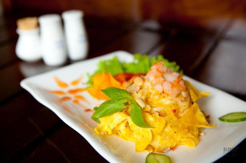 a plate of food with shrimp and vegetables on a table at Mercury Central Hotel Hanoi in Hanoi
