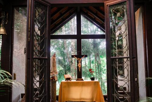 a altar in a room with a large window at Urikana Boutique Hotel in Teresópolis