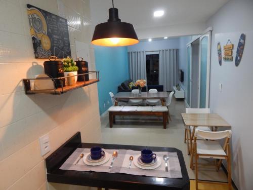 a living room with a table and a dining room at Varandas da Praia do Forte - Apartamento frente ao Mar in Cabo Frio