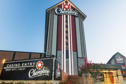 a casino entry sign in front of a building at Cherokee Casino Hotel Roland in Roland