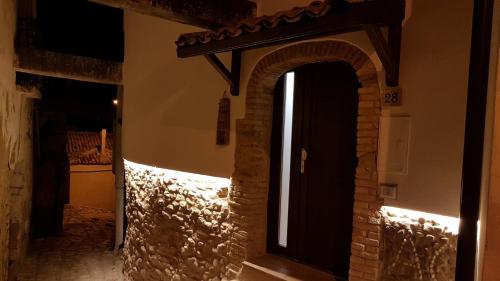 a room with a door with a stone wall at Il Centro Storico in Grottole
