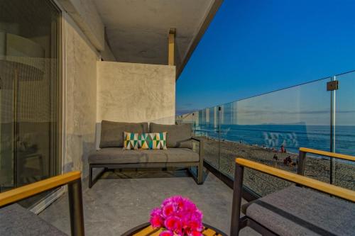 a couch on a balcony with a view of the ocean at Ocean Villas Beach Front in Carlsbad