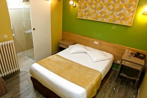 a small bedroom with a bed and a shower at Hotel de France in Brussels