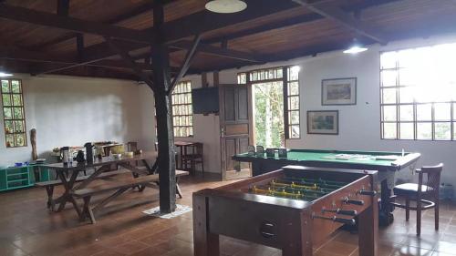 a room with a table and a pool table at Gran Camping Cabanas da Fazenda in Visconde De Maua