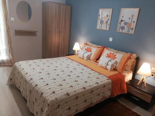 a bedroom with a large bed with two lamps at Central Apartment in Thessaloniki