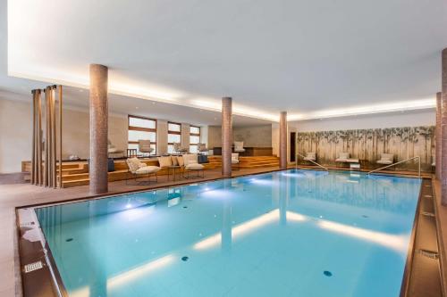 a large swimming pool in a hotel room at Grand Hotel Savoia Cortina d'Ampezzo, A Radisson Collection Hotel in Cortina dʼAmpezzo
