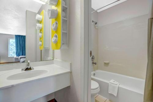a white bathroom with a sink and a toilet at Motel 6-Raleigh, NC - North in Raleigh