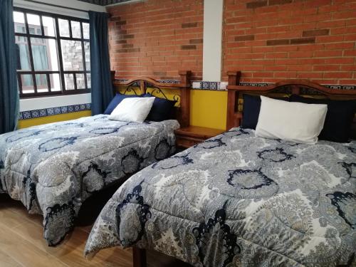 Cama o camas de una habitación en Hotel Y Suites Axolotl