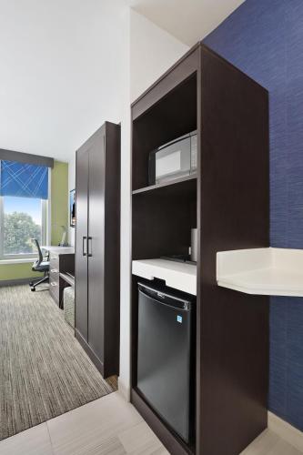 an office cubicle with a microwave and a desk at Hotel 1200 in Brooklyn