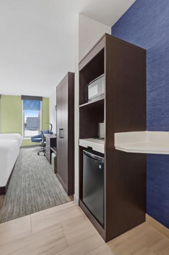 a room with a bed and a desk and a kitchen at Hotel 1200 in Brooklyn