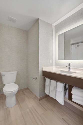 a bathroom with a toilet and a sink at Hotel 1200 in Brooklyn