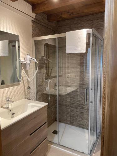 a bathroom with a shower and a sink at LA CASINA DE PAULA in Ríoseco