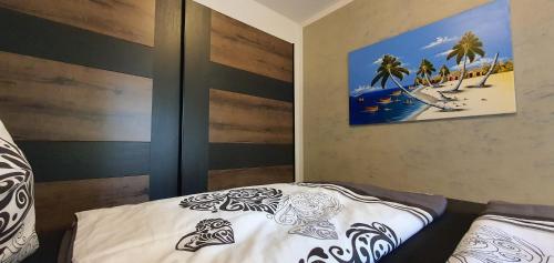 a bedroom with a bed and a picture of a beach at Beautiful Place a Lago d'Orta mit direktem Seezugang in Omegna